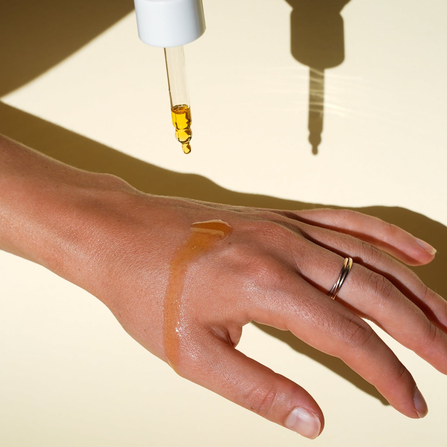 Biologi Br Rosehip Oil application from dropper onto hand