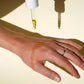 Biologi Br Rosehip Oil application from dropper onto hand